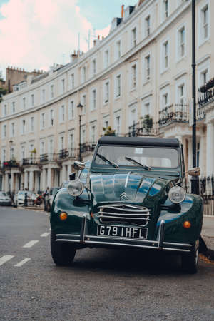 London, UK - June 20, 2020: Cars parked in front of white Victorian houses on a street in Holland park, an affluent area of West London favoured by celebrities.のeditorial素材