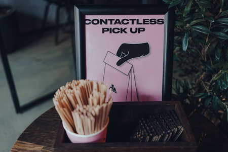 London, UK - July 02, 2020: Contactless pics up sign and station inside Joe & The Juice, chain of juice bars and coffee shops in over 200 locations around the world. Selective focus.のeditorial素材