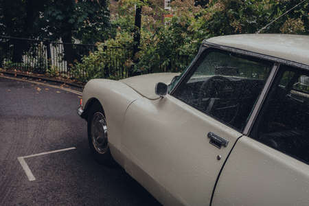 London, UK - July 02, 2020: Close up of retro car parked on a Hampstead street in the rain,...