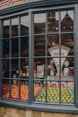 Broadway, UK - July 07, 2020: Fresh fruits and organic goods in a window of a Broadway Deli in Broadway, a large historic village within the Cotswolds in the county of Worcestershire, England.のeditorial素材