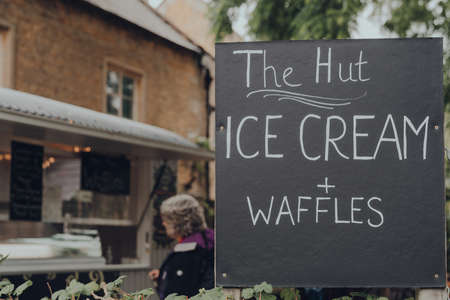 Bourton-on-the-Water, UK - July 12 2020: Ice Cream and Waffles sign for The Hut street food vendor in Bourton-on-the-Water, a famous village in rural Cotswolds area of England.のeditorial素材