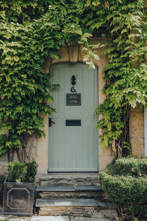 Stow-on-the-Wold, UK - July 10, 2020: Plant-framed doorway entrance to a traditional limestone house in Stow-on-the-Wold, a market town in Cotswolds, UK, built on Roman Fosse Way.のeditorial素材