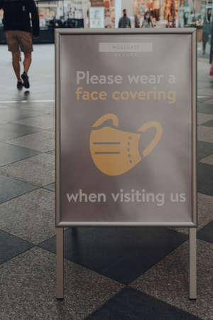 Oxford, UK - August 04, 2020: Please wear a face covering sign inside The Westgate Centre, a major shopping centre in Oxford city centre, England.のeditorial素材