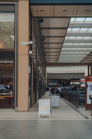 Oxford, UK - August 04, 2020: Face covering and social distancing signs inside nearly empty Westgate...