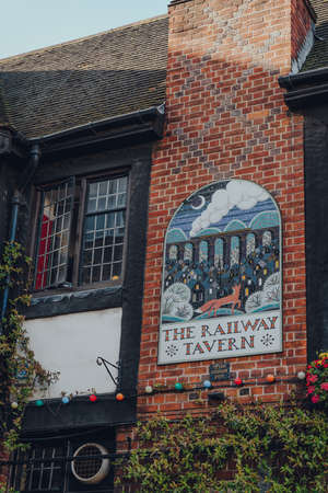 London, UK - August 20, 2020: Ornate tiles sign by Tessa Hunkin on a brick wall of The Railway...