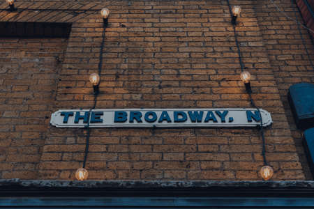 Street name sign amongst a string of lights on The Broadway, Crouch End, London, UK.のeditorial素材