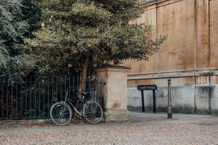 Oxford, UK - August 04, 2020: Bicycle parked against the metal fence in Oxford, UK. Cycling is a popular way of getting around the city.のeditorial素材