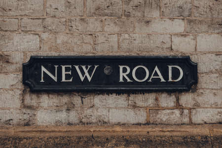 Metal street name sign on a wall of a building on New Road in Oxford, UK.のeditorial素材
