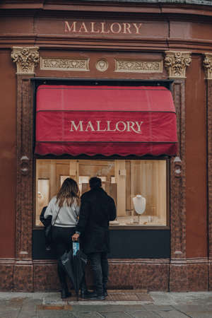 Bath, UK - October 04, 2020: Couple looking at window display of Mallory jewellery store in Bath,...