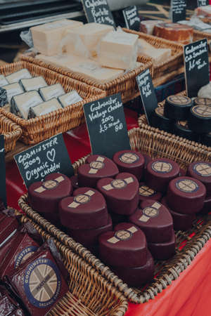 Frome, UK - October 07, 2020: Variety of local cheeses on sale at a street market in Frome, a market town in the county of Somerset famous for its market and independent shops.のeditorial素材