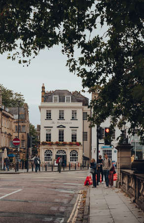 Bath, UK - October 04, 2020: View of The Huntsman pub in Bath, the largest city in Somerset known for and named after its Roman-built baths, people on the crossing in front, selective focus.のeditorial素材