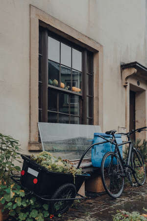 Frome, UK - October 07, 2020: Bike with a tow basket parked outside a traditional stone house in Frome, a market town in the county of Somerset famous for its market and independent shops.のeditorial素材