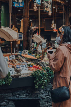 London, UK - November 19, 2020: Fresh fish on sale at a fishmonger stall in Borough Market, one of...