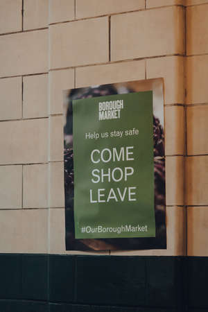 London, UK - November 19, 2020: Help us stay safe sign in Borough Market, one of the largest and oldest food markets in London, that are required indoor due to Coronavirus pandemic.のeditorial素材