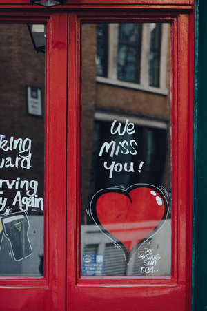 London, UK - November 19, 2020: We miss you heart sign on a door of a closed pub in London. Pubs and...