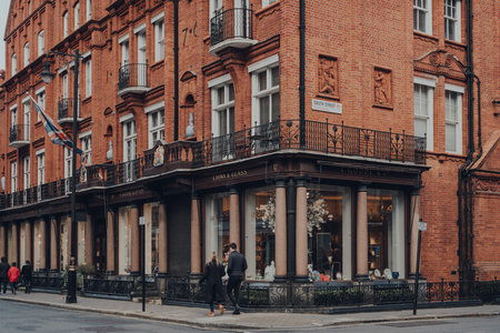 London, UK - December 5, 2020: Exterior of T. Goode Designers and Co china and glass shop in Mayfair, an affluent area in the West End of London, people walking past, motion blur.のeditorial素材