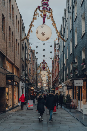 London, UK - December 5, 2020: People walking under Christmas decorations in St Christopher's Place, a vibrant urban quarter in London featuring high-street and indie boutiques and restaurants.のeditorial素材