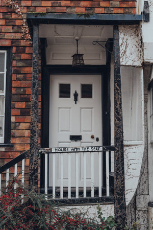 Rye, UK - October 10, 2020: White front door of old crooked House With The Seat house on Mermaid Street in Rye, one of the best-preserved medieval towns in East Sussex, England.のeditorial素材