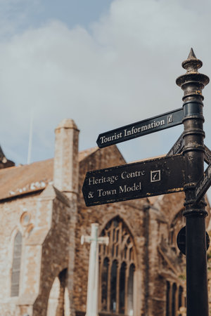Rye, UK - October 10, 2020: Directional signs on a lamp post in front of St. Mary's church in Rye, one of the best-preserved medieval towns in East Sussex, England.のeditorial素材
