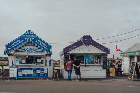 Eype Beach, UK - July 25, 2020: People buying take away food from food stalls West Bay, a small harbour settlement and resort on the English Channel coast in Dorset.のeditorial素材