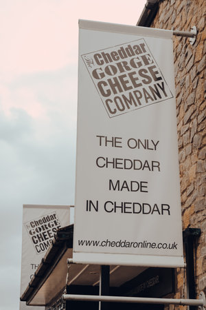 Cheddar, UK - July 26, 2020: Sign outside The Cheddar Gorge Cheese Company shop in Cheddar, a village famous for its Gorge and is the birthplace of world famous cheese.のeditorial素材