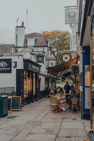 London, UK - October 10, 2020: People at the outdoor tables of cafes on Golden Court, a street in Richmond, a suburban town in south-west London famous for large number of parks.のeditorial素材