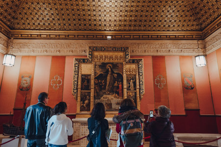 Seville, Spain - January 19, 2020: Icon at Sala de Audiencias inside Alcazar of Seville, a royal palace built for the Christian king Peter of Castile, people in front, selective focus.のeditorial素材