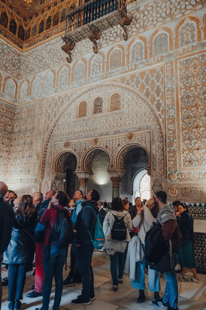 Seville, Spain - January 19, 2020: Interior of Hall of Ambassadors inside Alcazar of Seville, a royal palace built for the Christian king Peter of Castile, tourists inside, selective focus.のeditorial素材