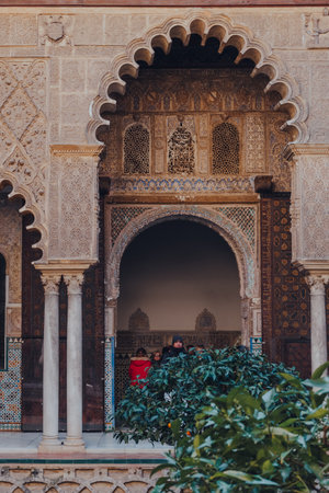 Seville, Spain - January 19, 2020: Arched entrance to Patio de Maidens courtyard inside Alcazar of...