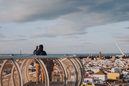 Seville, Spain - January 19, 2020: Tourists on a walkway on top of Metropol Parasol, the largest wooden structure in the world, in La Encarnacion square Seville, Spain.のeditorial素材