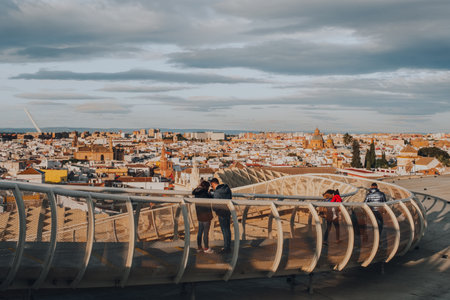 Seville, Spain - January 19, 2020: Tourists on a walkway on top of Metropol Parasol, the largest wooden structure in the world, in La Encarnacion square Seville, Spain.のeditorial素材