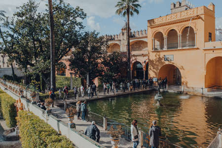 Seville, Spain - January 19, 2020: High angle view of tourists by the Mercury Pond next to Grutescos Gallery in Alcazar of Seville, a Royal palace built for the Christian King Peter of Castile.のeditorial素材