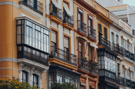 Close up of a row of traditional apartment blocks on a street in Seville, Andalusia, Spain.の写真素材