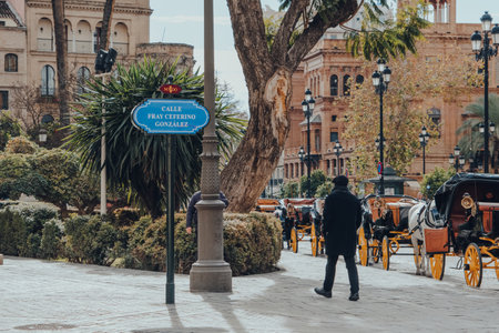 Seville, Spain - January 19, 2020: Street name sign on Calle Fray Ceferino Gonzales street in Seville, the capital of Andalusia region in Southern Spain, man walking past.のeditorial素材
