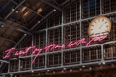 London, UK - August 16, 2019:"I want my time with you" glowing pink words installation by Tracey Emin within interior of St. Pancras, one of the largest railway stations in London and home to Eurostarのeditorial素材