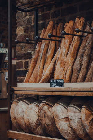 London, UK - August 16, 2019: Fresh bread on sale in Le Pain Quotidien, an international chain of bakery-restaurants. Selective focus.のeditorial素材