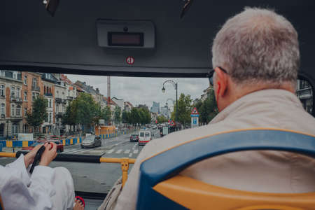 Brussels, Belgium - August 16, 2019: View from top of the tour bus of a street in Brussels, the capital of Belgium and a popular city break destination. Selective focus.のeditorial素材