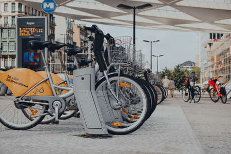Brussels, Belgium - August 16, 2019: Row of yellow Villo! bikes, a public bicycle rental programme, on a street in Brussels, the capital of Belgium and a popular city break destination.のeditorial素材
