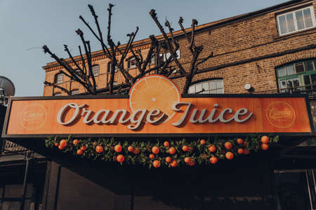 London, UK - August 12, 2020: Sign on the fresh Orange Juice stall in Camden Market. Started with 16 stalls in 1974, Camden Market is one of the busiest retail destinations in London.のeditorial素材