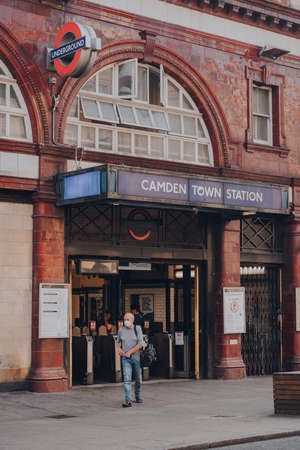 London, UK - August 12, 2020: View of Camden Town Underground station, a major junction for Northern Line where the Edgware and High Barnet branches merge, man wearing face mask walking out.のeditorial素材