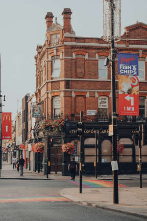 London, UK - August 12, 2020: Closed pubs and shops on empty High Street in Camden Town, London, an area famed for its market and nightlife and popular with tourists, teenagers and punks.のeditorial素材
