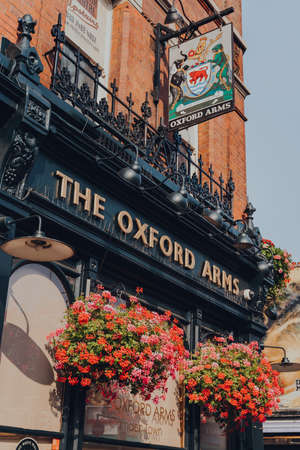 London, UK - August 12, 2020: Name sign and emblem on the facade of The Oxford Arms pub on empty High Street in Camden Town, London, an area famed for its market and nightlife.のeditorial素材