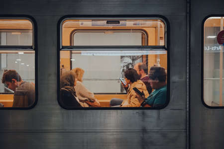 Brussels, Belgium - August 16, 2019: View through window of people inside Brussels Metro carriage. Consisting of four metro and three premetro lines it serves large part of Brussels-Capital Region.のeditorial素材
