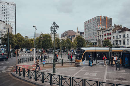 Brussels, Belgium - August 16, 2019: High angle view of people boarding a tram at a stop in Brussels, the capital of Belgium and a popular city break destination. City life.のeditorial素材