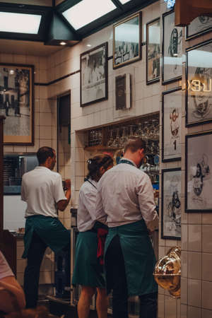Brussels, Belgium - August 17, 2019: Staff working inside Chez Leon, a family-owned restaurant in Brussels, established in 1893 and known for regional cuisine including mussels and fries.のeditorial素材