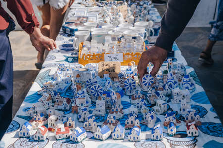 Ana Mera, Greece - September 24, 2019: Tourists browsing souvenirs at the market stalls in Ana Mera,...