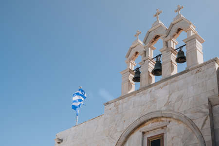 Ana Mera, Greece - September 24, 2019: Low angle view of bells on Panagia Tourliani Monastery, a whitewashed church and monastery on Mykonos dating from the 16th century.のeditorial素材