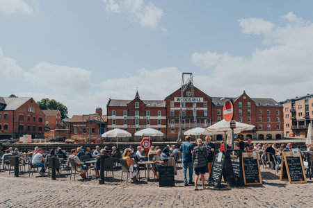 York, UK - June 22, 2021: People at the outdoor tables of a pub on the bank of the River Ouse in...
