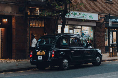 London, UK - October 23, 2021: Black cab on a street in Holborn, London. Black cabs are an important part of the capital's transport system.のeditorial素材