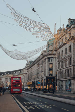 London, UK - November 23, 2021: Angel Christmas lights on Regent Street, a major shopping street in the West End, London, red double decker bus on the background.のeditorial素材